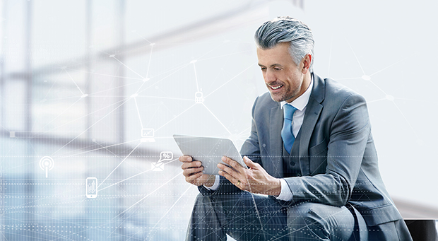 Businessman using a tablet outside in the city.