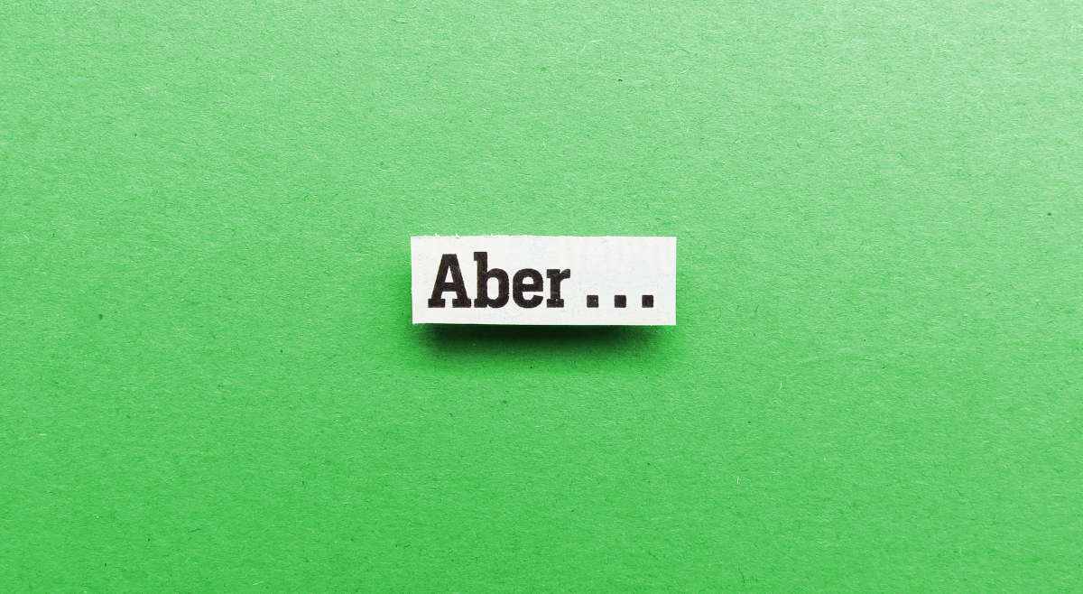 Grüner Hintergrund, auf dem das Wort "Aber" gezeigt ist.