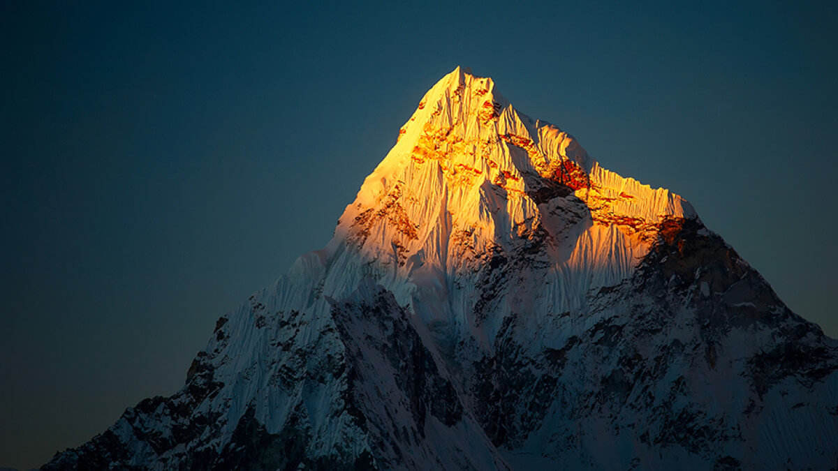 Bild eines von der Sonne beschienenen Berggipfels