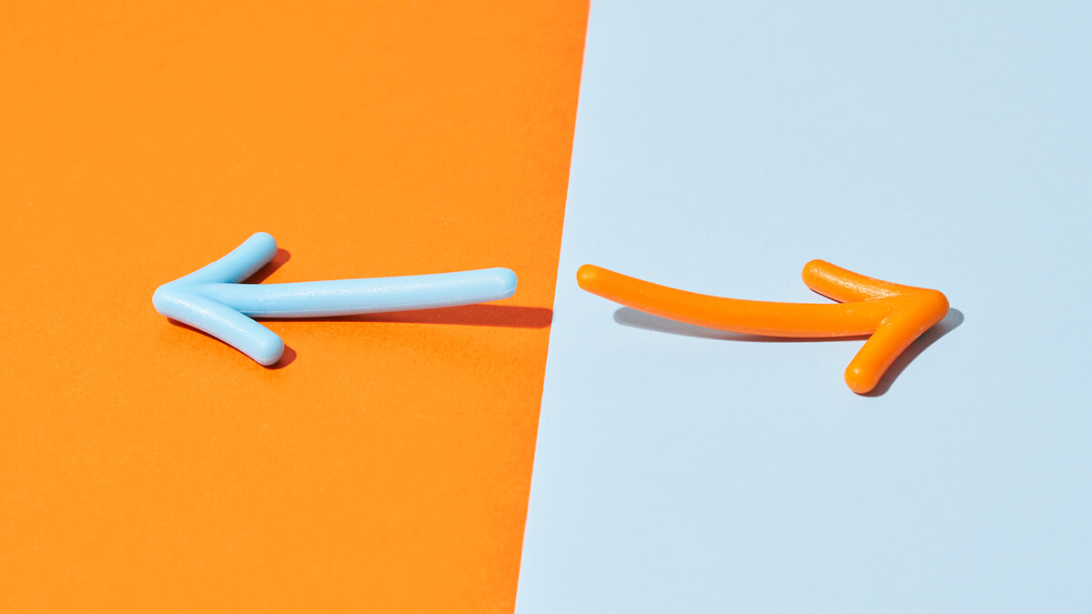 Ein gelber Pfeil auf hellblauem Hintergrund und ein hellblauer Pfeil auf gelbem Grund, die in entgegengesetzte Richtungen zeigen.