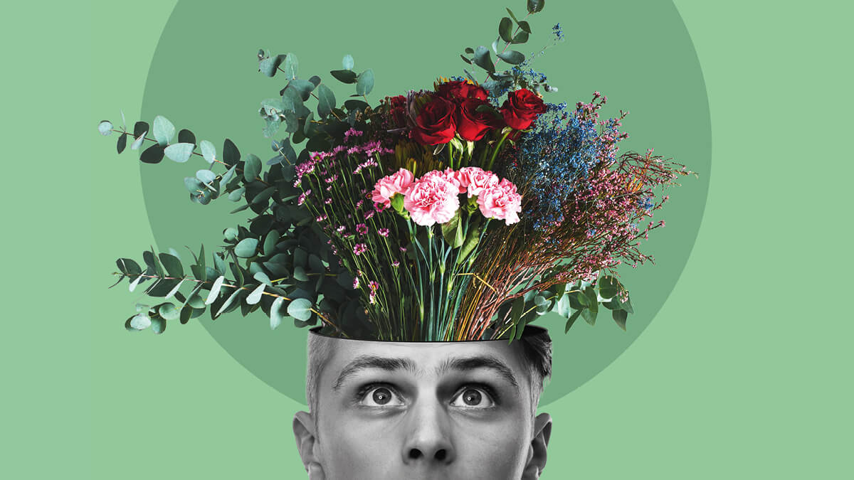 Eine Collage mit einem Kopf in schwarz-weiß, aus dem, wie aus einer Vase, ein Blumenstrauß heraus schaut.